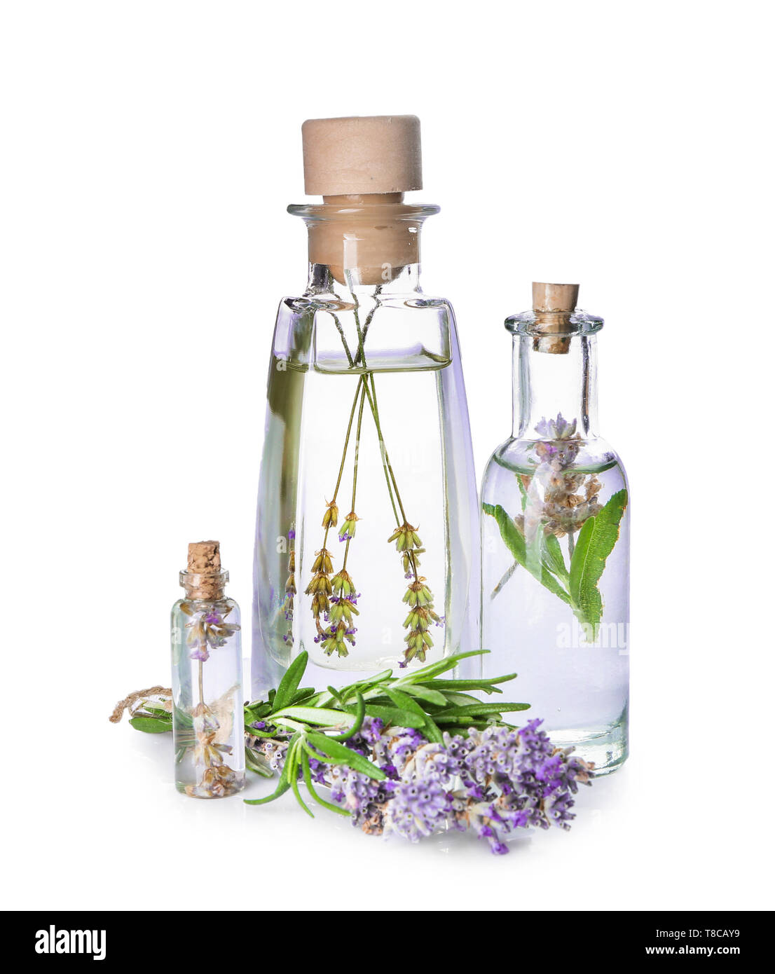 Bottles of essential oil with lavender and rosemary on white background ...