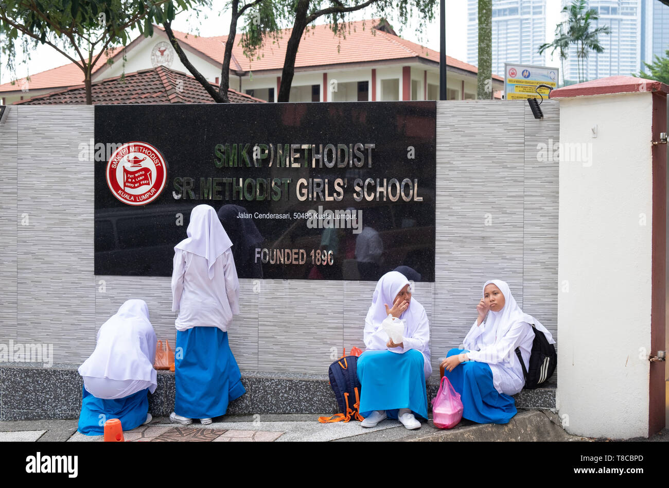 Girls waiting outside school, Kuala Lumpur, Malaysia Stock Photo