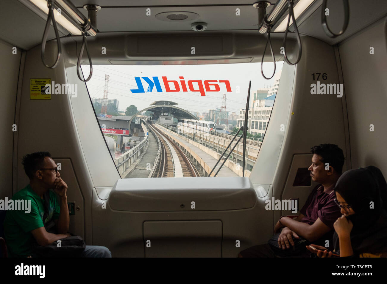 Windowless Metro Train Passengers looking through window of driverless commuter train as it ...
