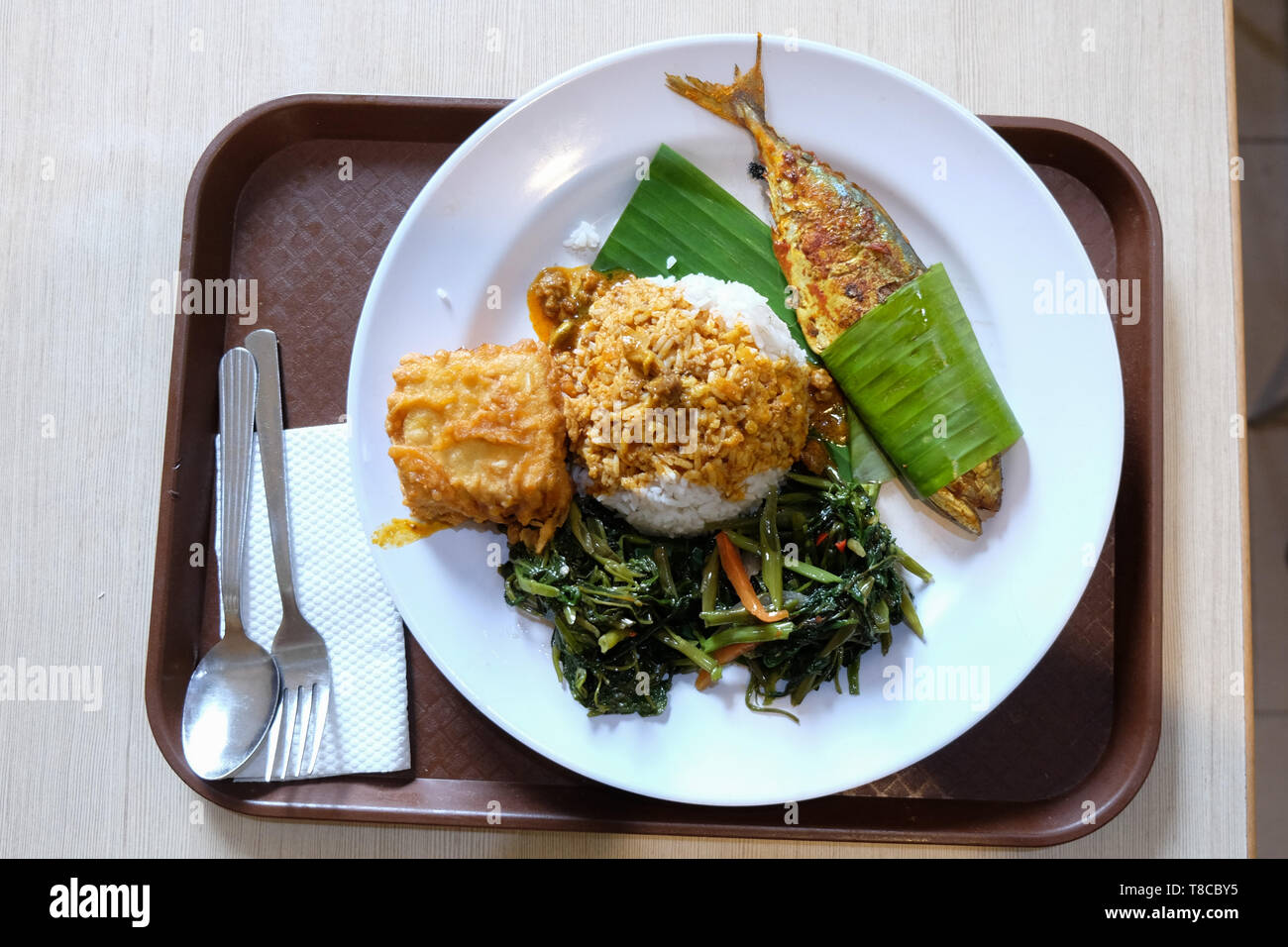Fried fish ,rice and vegetables, local dish in a street restaurant in Kuala Lumpur, Malaysia