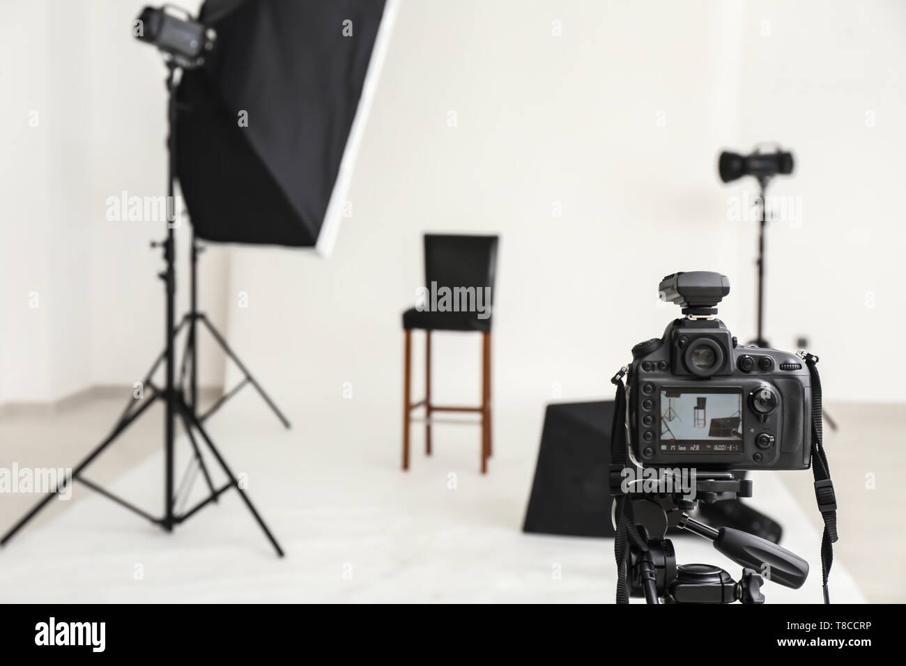 Professional camera on tripod in photo studio Stock Photo - Alamy
