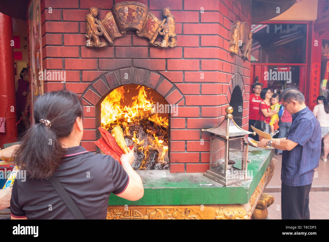 Traditional Chinese New Year ritual of the burning of replica paper money and joss paper ,Chinese worship in a temple, Kuala Lumpur,Malaysia Stock Photo