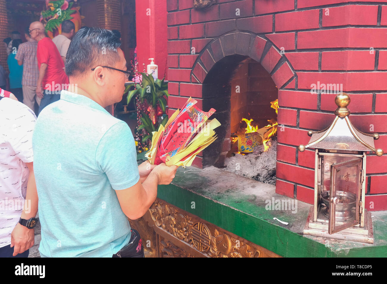 Traditional Chinese New Year ritual of the burning of replica paper money and joss paper ,Chinese worship in a temple, Kuala Lumpur,Malaysia Stock Photo