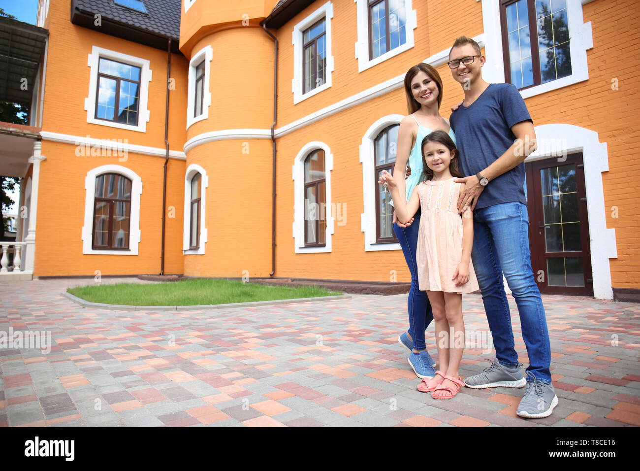 Happy family with key near their new house outdoors Stock Photo - Alamy