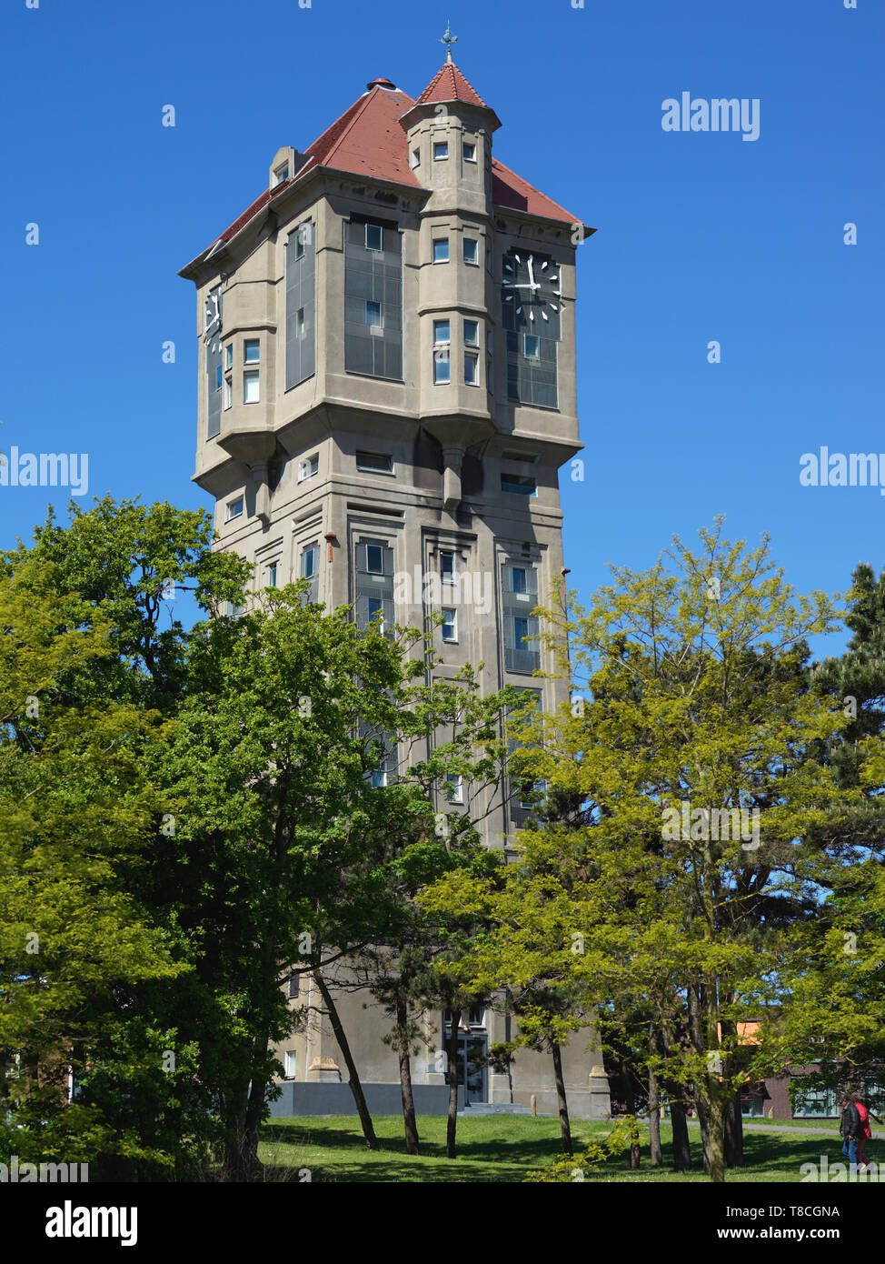 The old Watertower of IJmuiden build in 1915. As watertowers are not needed anymore it has been restructured in luxe condominiums with a grand view. Stock Photo
