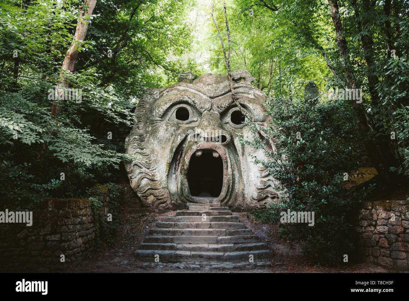 Orcus mouth sculpture at famous Parco dei Mostri (Park of the Monsters), also named Sacro Bosco (Sacred Grove) or Gardens of Bomarzo in Bomarzo Stock Photo
