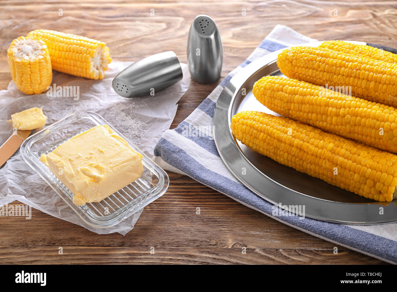 Composition with boiled corncobs on wooden table Stock Photo