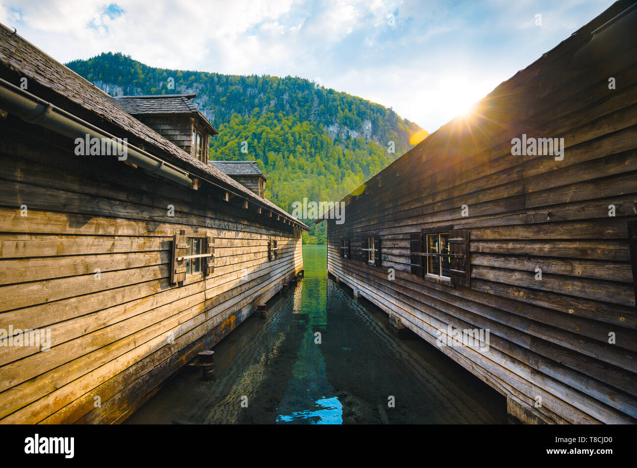 Beautiful view of traditional wooden boathouses at the shores of famous Lake Königssee at sunset, Bavaria, Germany Stock Photo