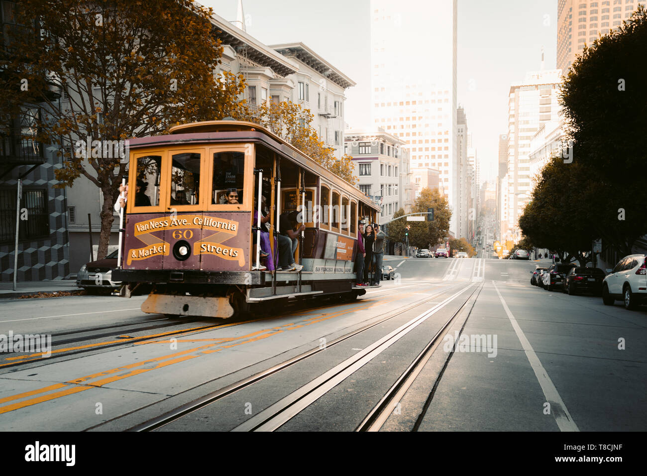 SAN FRANCISCO, USA - September 5, 2016: Historic Cable Cars riding on famous California Street in beautiful golden evening light at sunset, San Franci Stock Photo