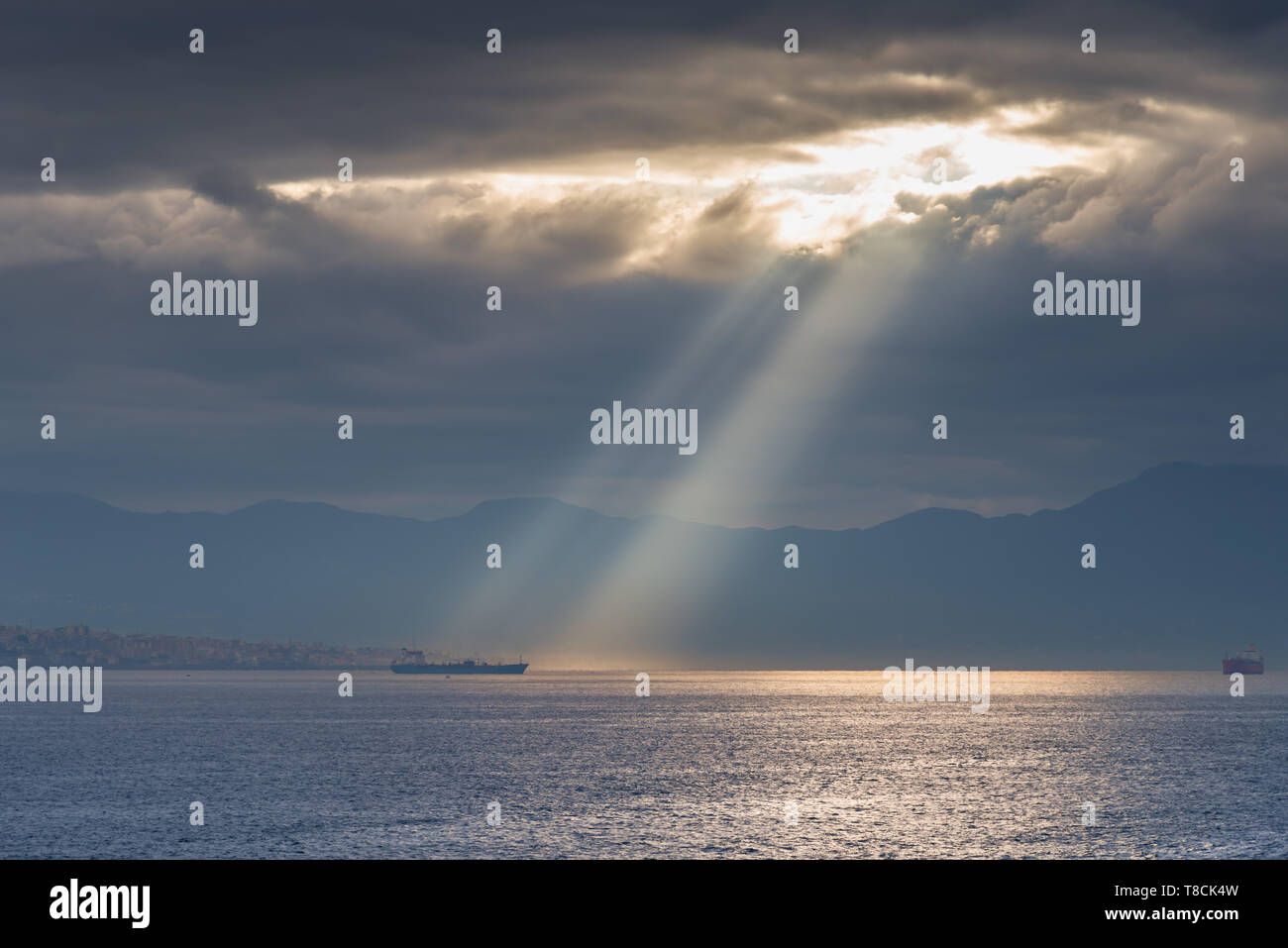 God Rays shining on ship Stock Photo