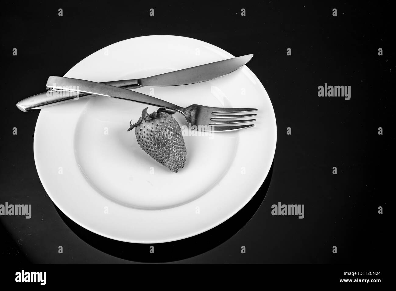 strawberry with dish on white plate in black and white Stock Photo - Alamy