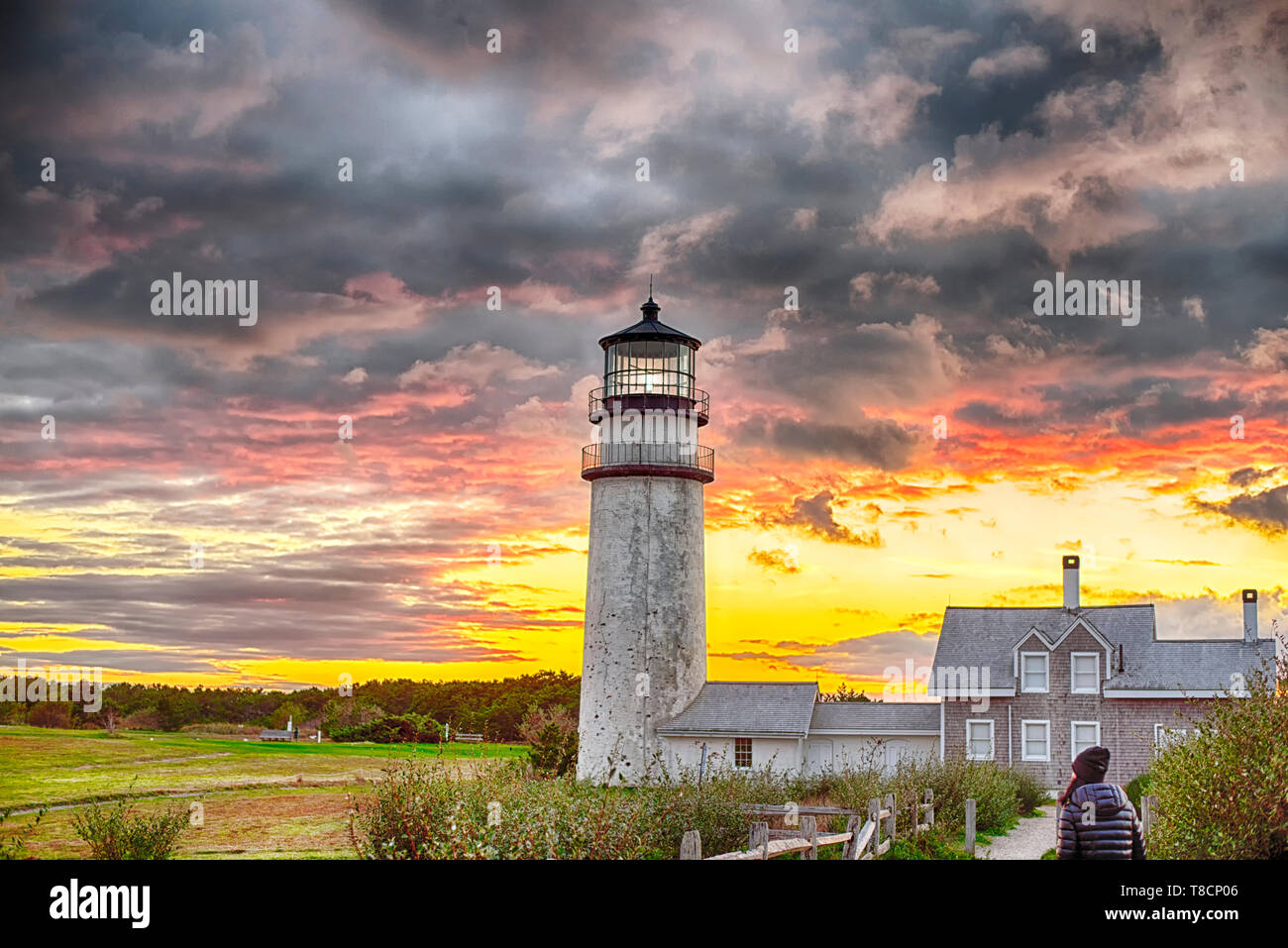 The Highland Lighthouse against a beautiful dramatic sunset in North Truro Massachusetts on the Cape Cod National Seashore. Stock Photo