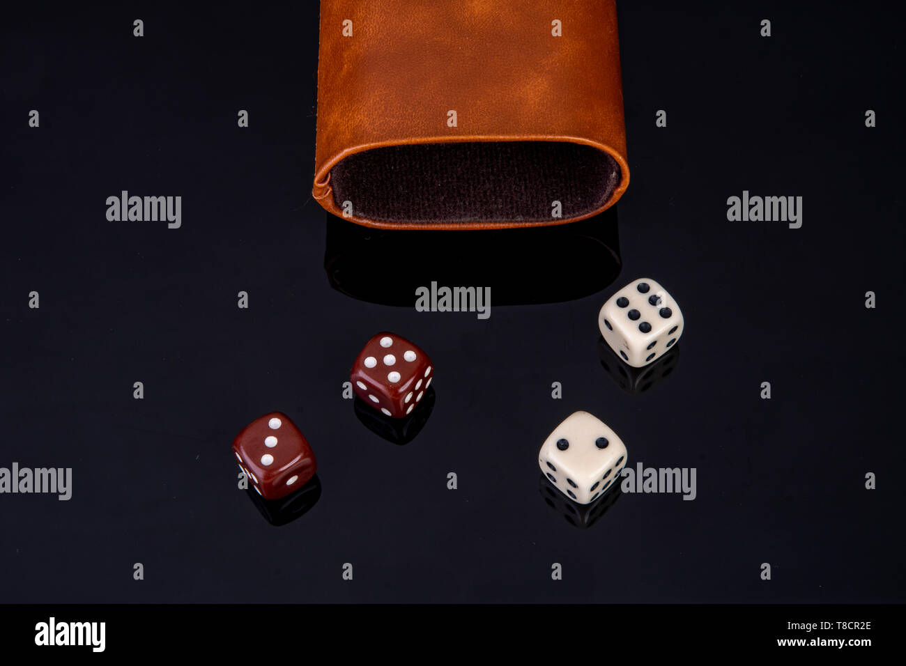 Dice with dice cup on black background Stock Photo