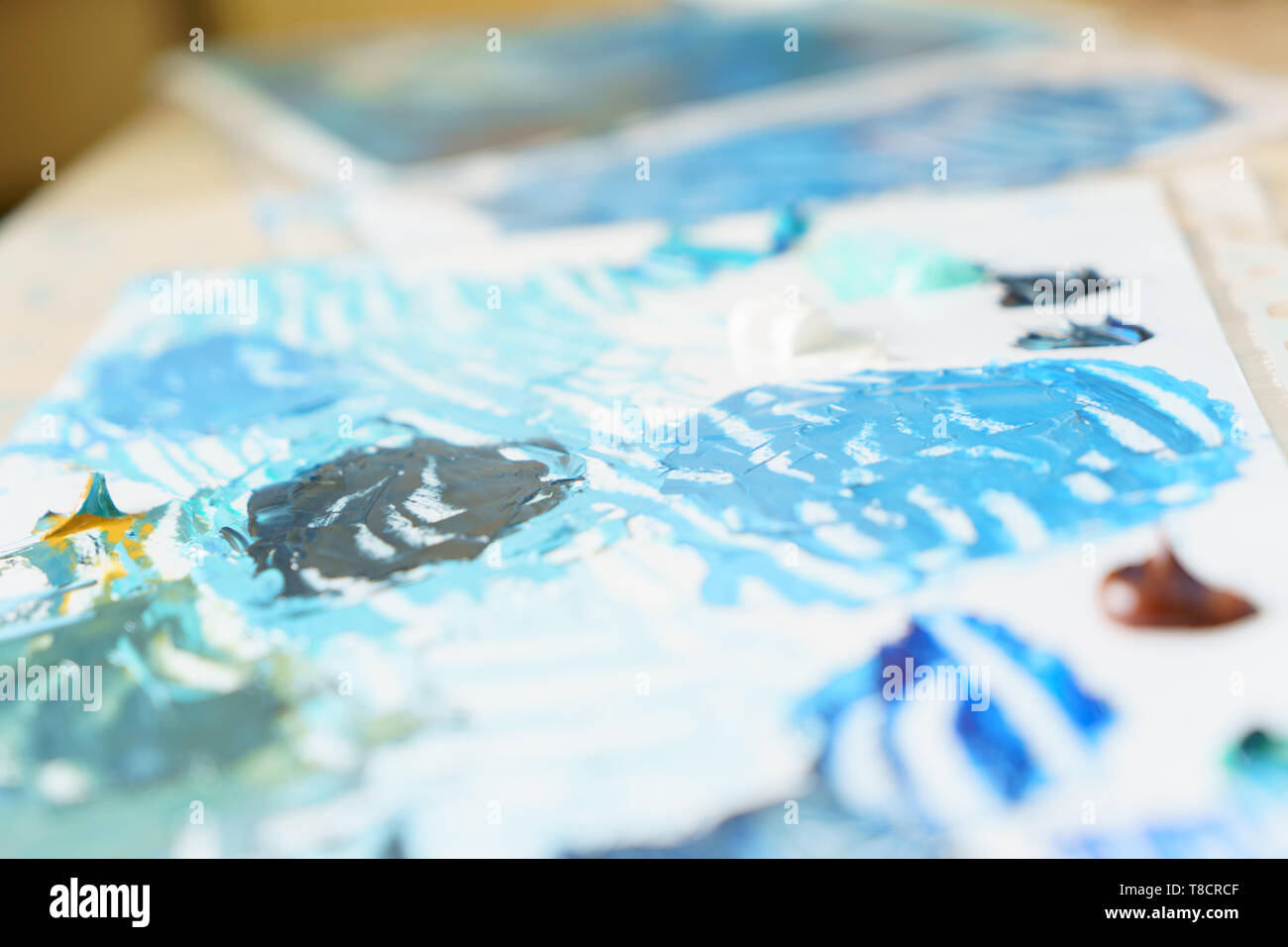 palette with oil paints with blue hues, horizontal frame, sunny, daylight Stock Photo