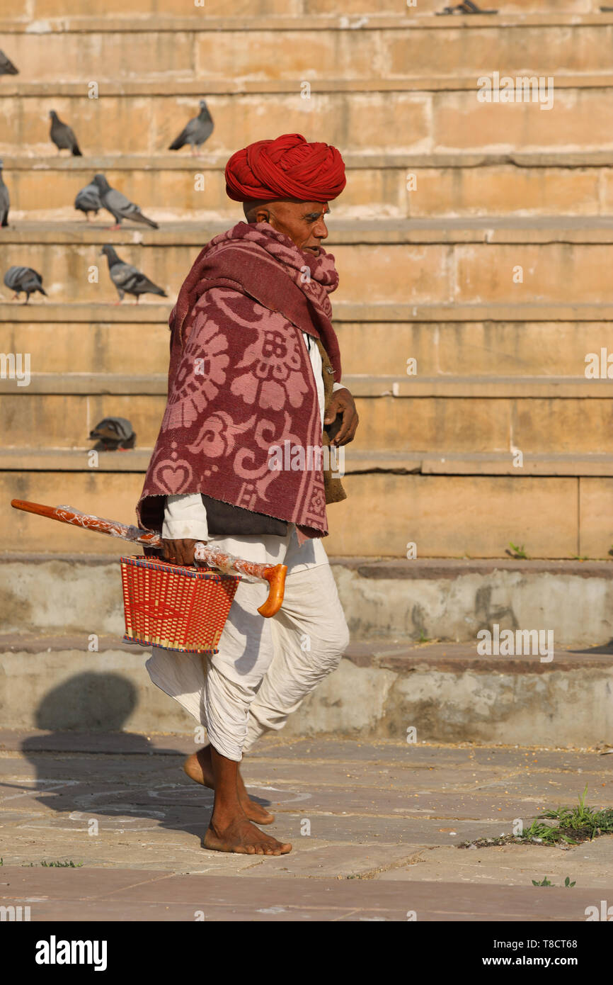Man walking on the steps of  Pushkar Stock Photo