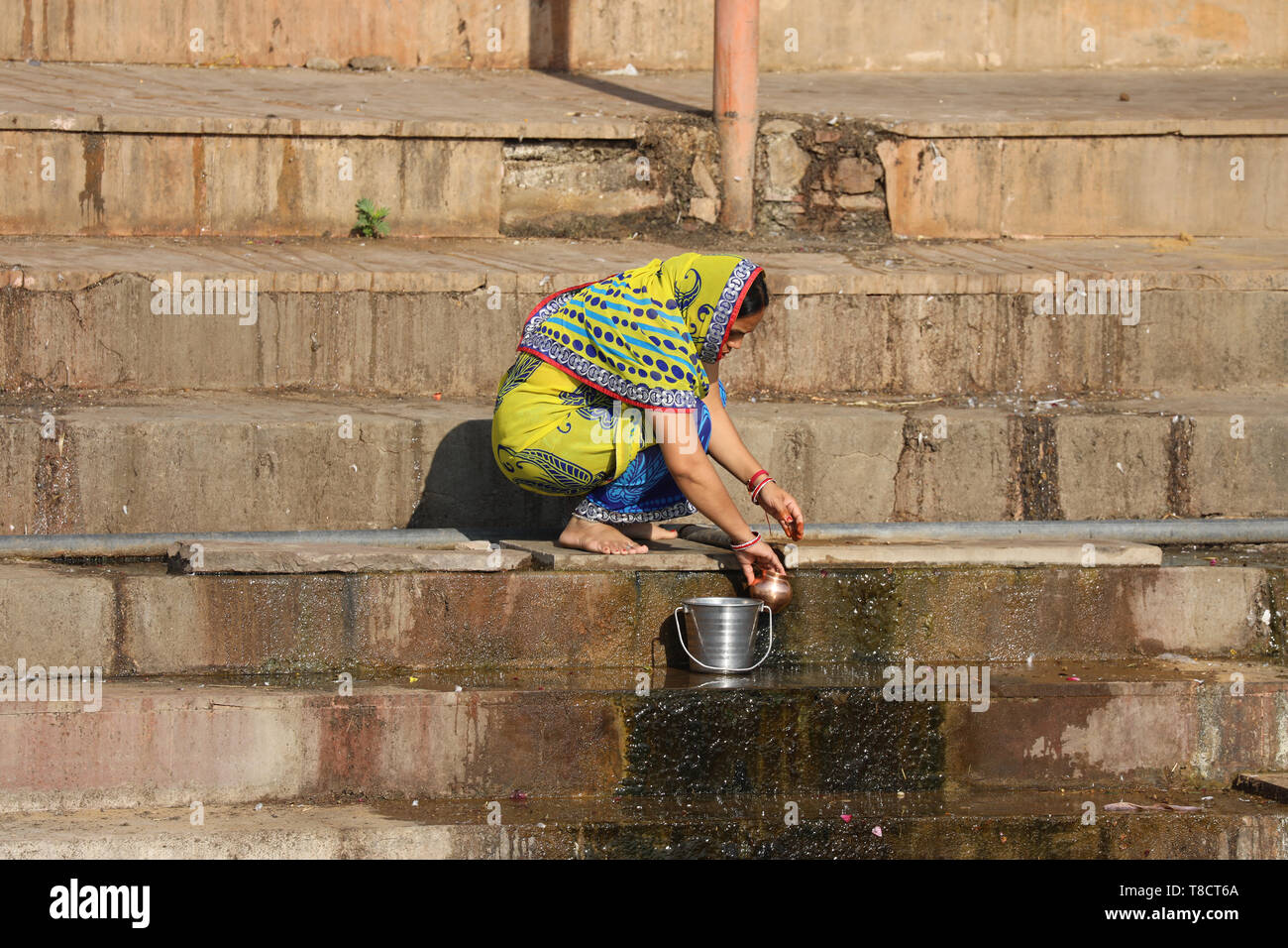Woman Colecting Water Stock Photo