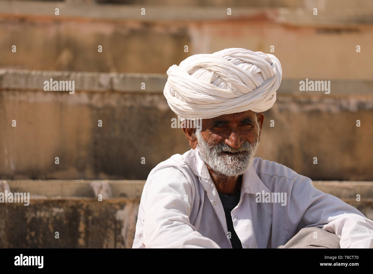 old Man sitting on Steps in Pushkar Stock Photo