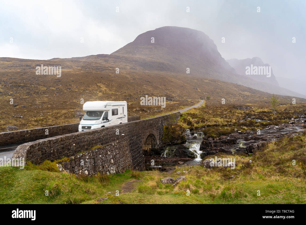 Bridge and motorhome in the rain at start of climb into Bealach na Ba pass on Applecross Peninsula  the North Coast 500 scenic driving route in northe Stock Photo