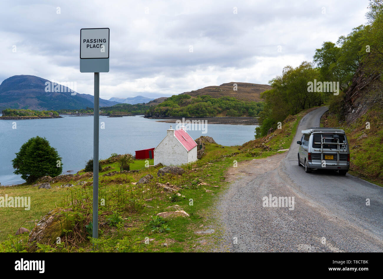 Single track highway and passing place and tourist camper van on the North Coast 500 scenic driving route in Torridon Scotland, UK Stock Photo