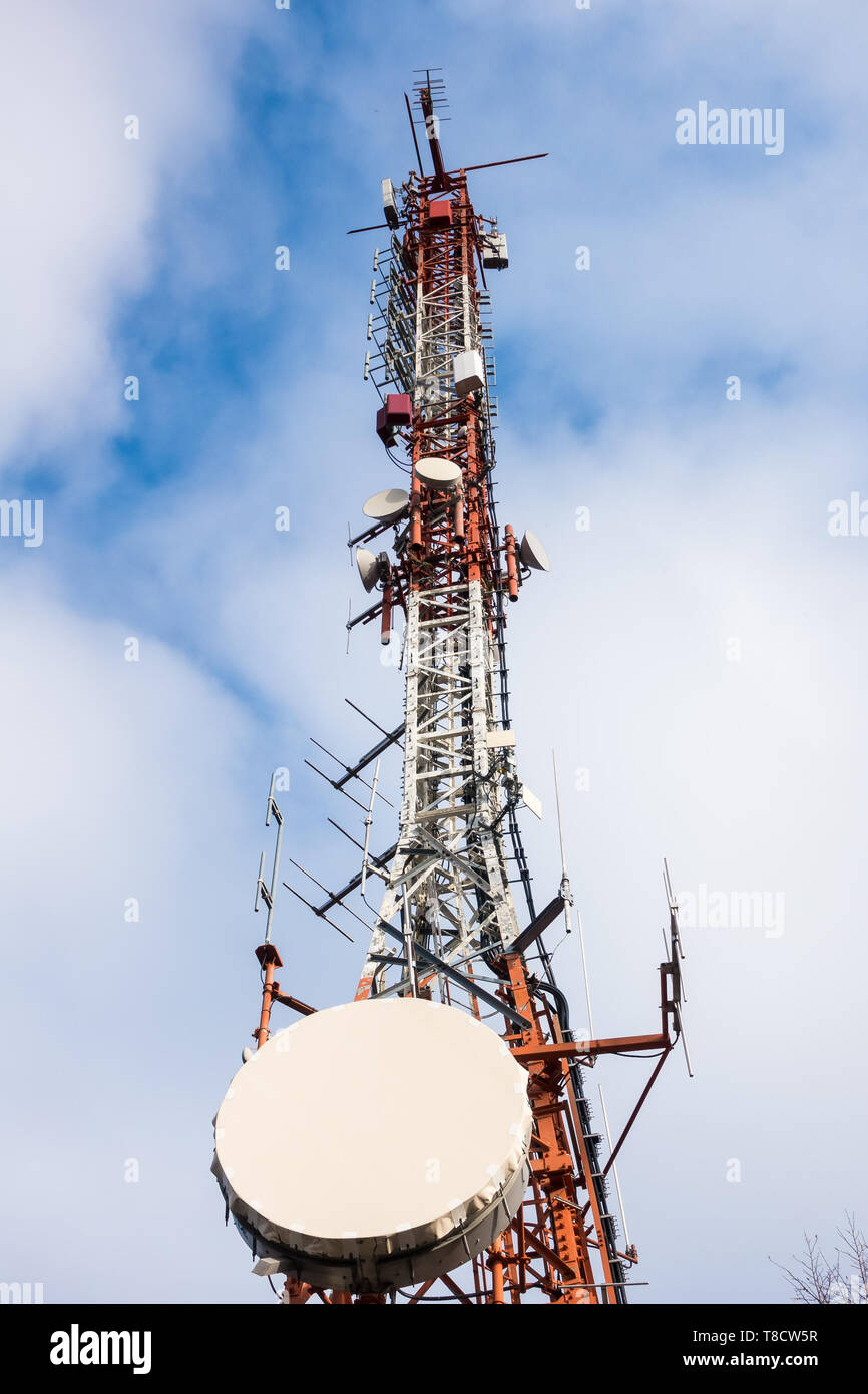 Telecommunication mast TV antennas wireless technology with blue sky in the morning Stock Photo