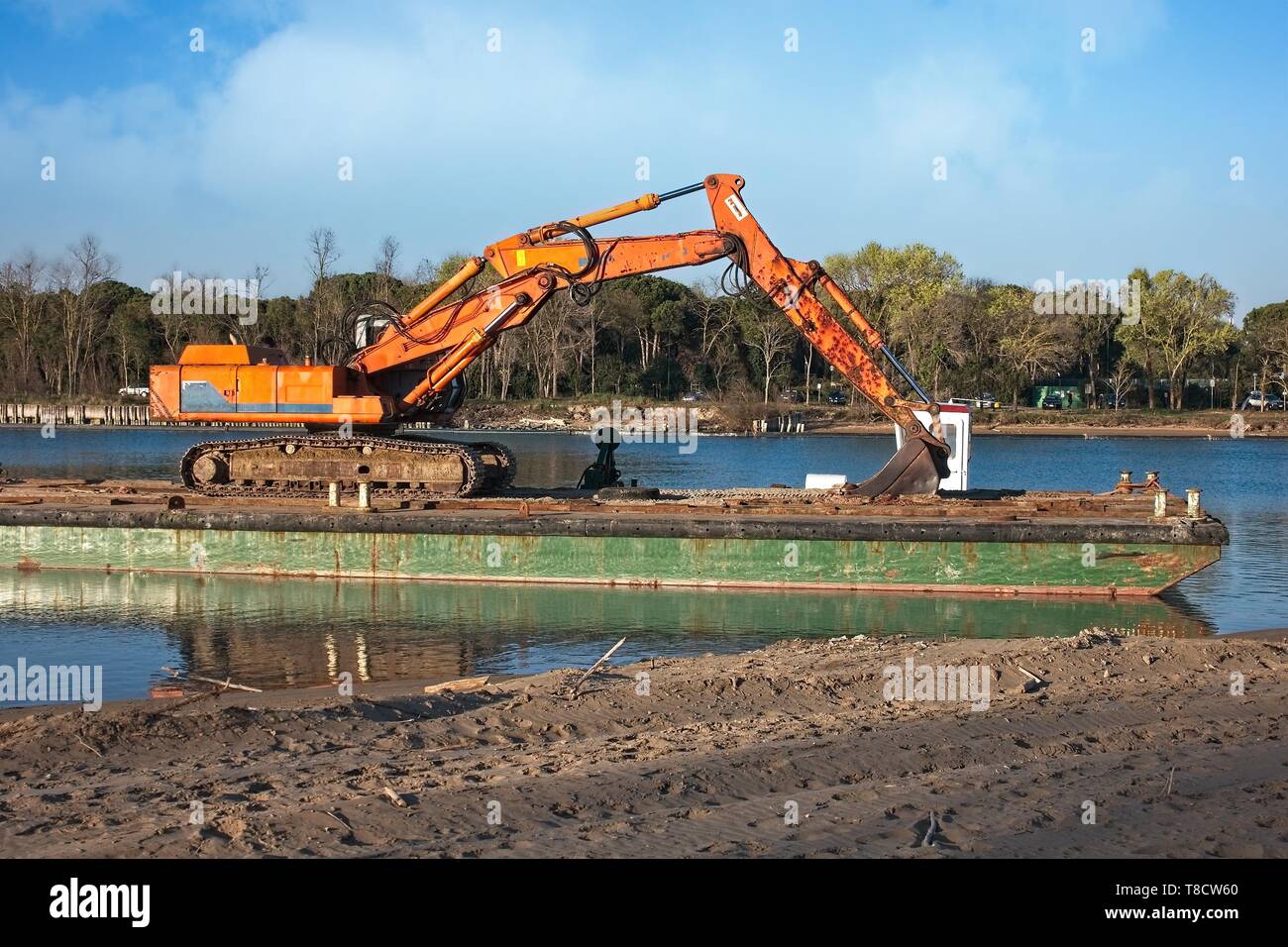 Excavator for channel dredge on a barge. Stock Photo