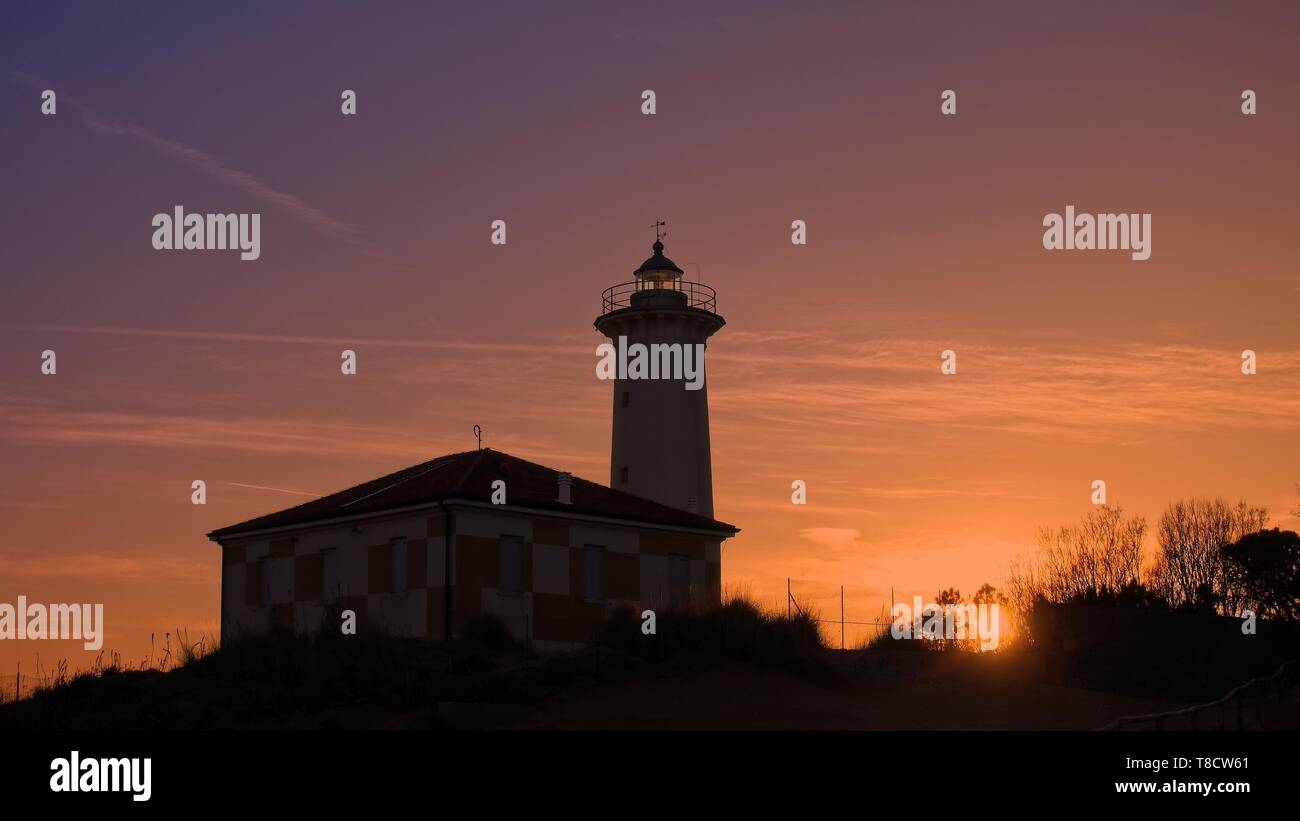 The lighthouse at sunset on the beach at the mouth of the river Tagliamento, Bibione, Venezia, Italy. Stock Photo