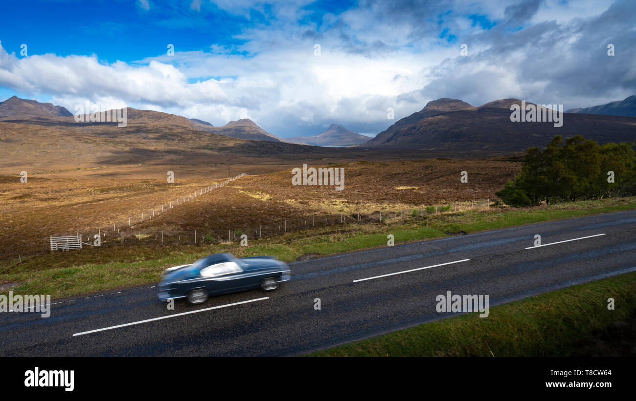 Car and mountains of Assynt on the North Coast 500 scenic driving route Scottish highlands, Scotland, UK Stock Photo