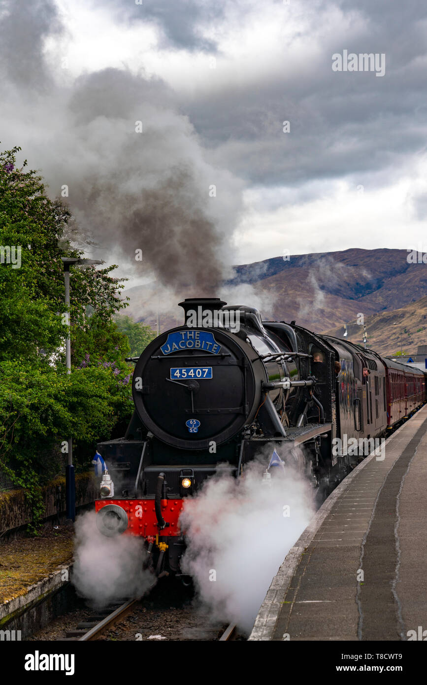The Lancashire Fusilier steam trail , known as The Jacobite, pulling tourist train on West Highland line at Fort William in Scotland, UK Stock Photo