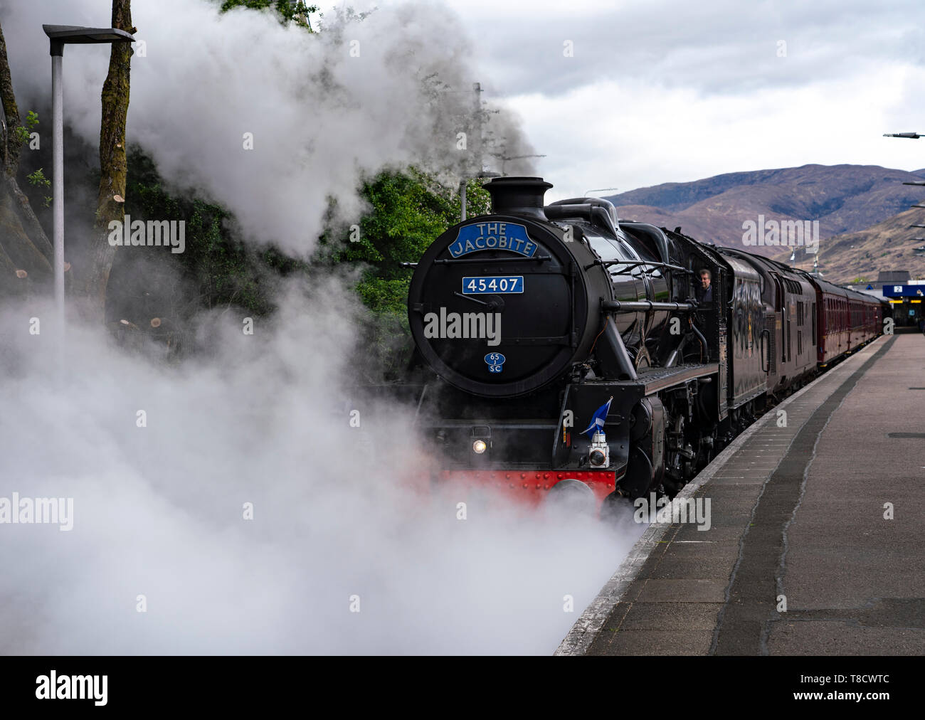 The Lancashire Fusilier steam trail , known as The Jacobite, pulling tourist train on West Highland line at Fort William in Scotland, UK Stock Photo