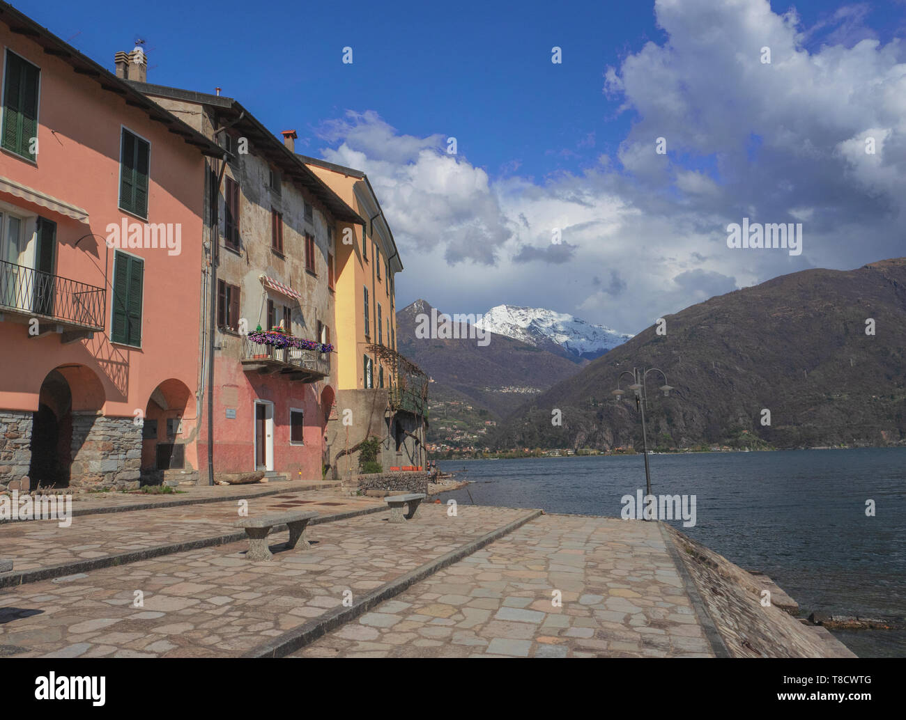 beautiful colorful houses of fishermen overlooking Lake Como, Italy. Panorama with clouds Stock Photo
