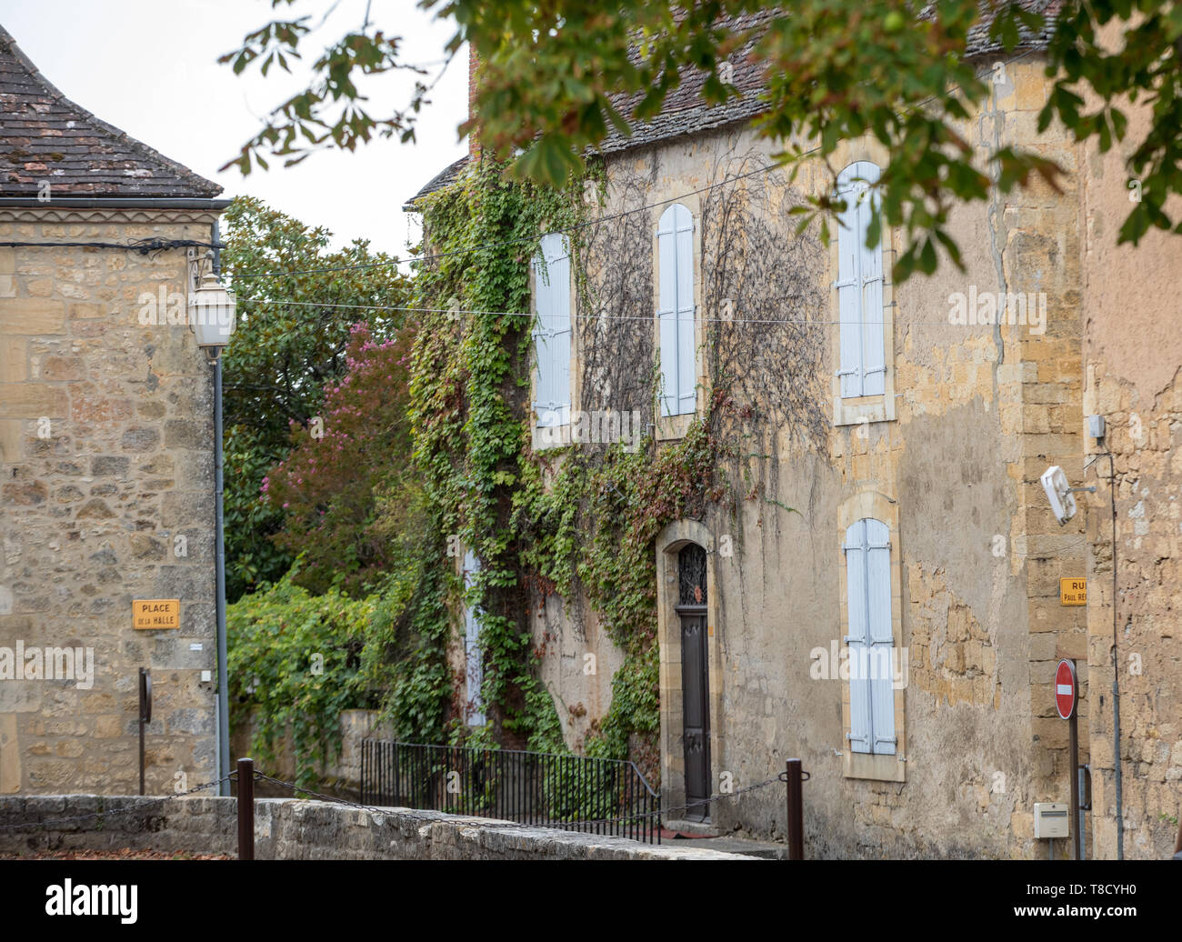 Domme, France - September 5, 2018: Old stone house with wooden shutters ...