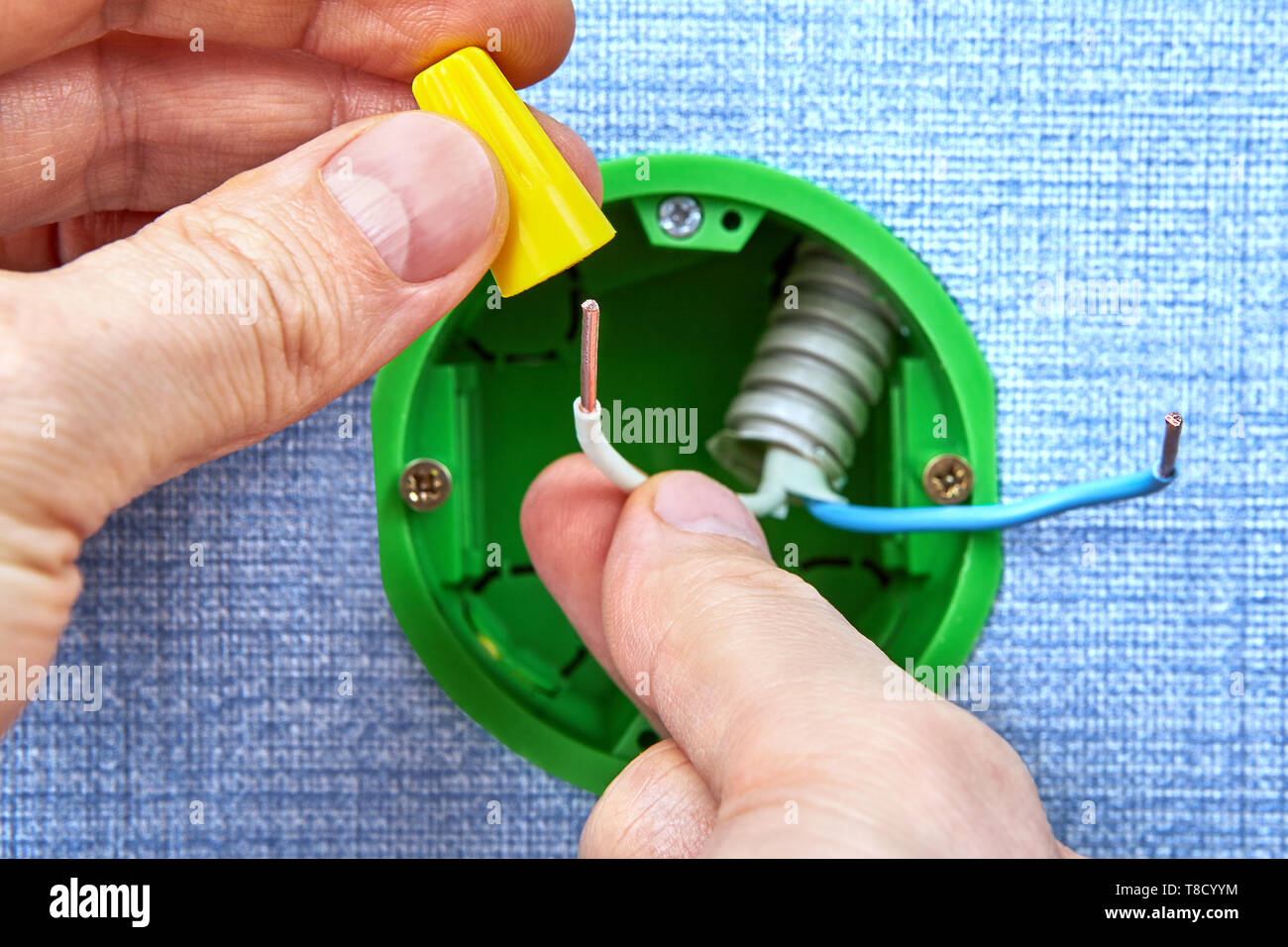 Electrician is putting electrical conductors on copper wires during