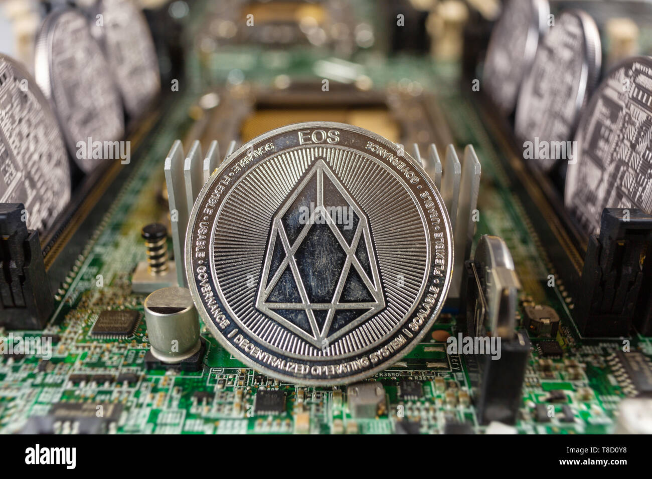 EOS coinclose-up on a computer circuit motherboard as a blockchain technology payment network. Digital cryptocurrency concept and mining. Stock Photo