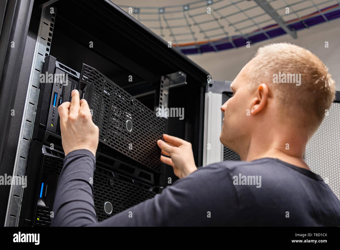 IT Consultant Working With Servers In Large Enterprise Datacenter Stock Photo
