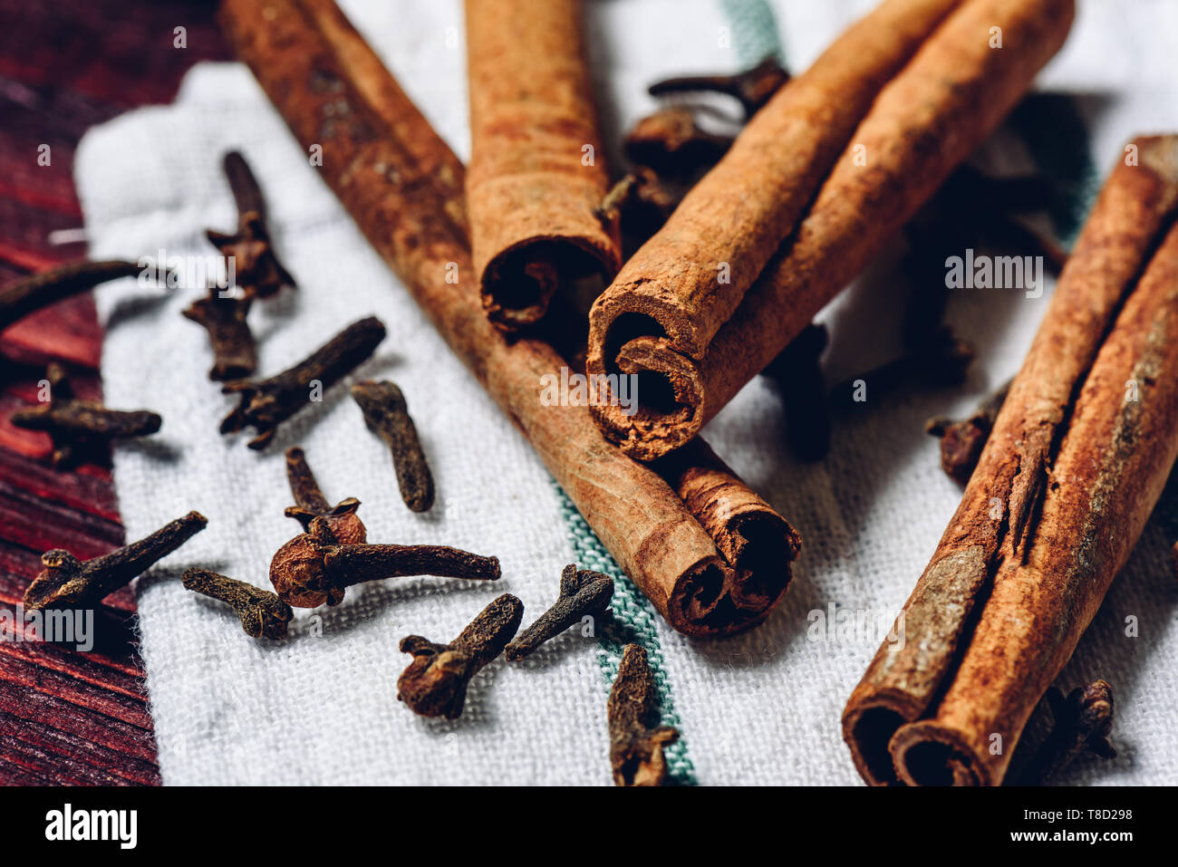 Cinnamon sticks and cloves on white kitchen towel Stock Photo Alamy