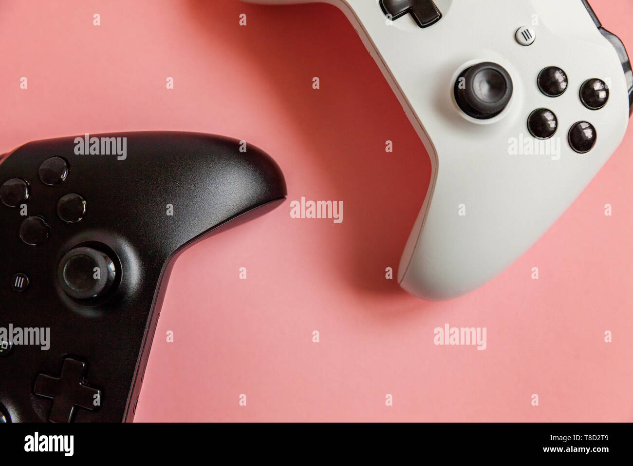 White and black two joystick gamepad, game console on pastel pink colourful  trendy pin-up background. Computer gaming competition videogame control co  Stock Photo - Alamy
