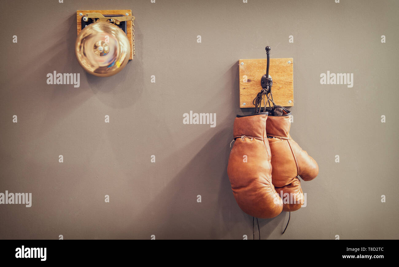 history of sport. vintage gong and worn gloves. stamina. final gong in