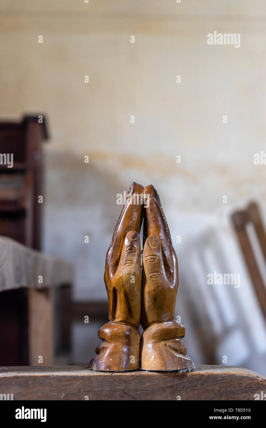 Praying wooden hands inside St John the Baptist Church cared for by the CCT, a redundant church in Upper Eldon, Hampshire, England, UK Stock Photo
