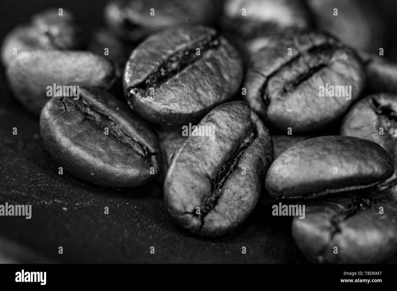 Brown roasted coffee beans on black background, close-up, macro Stock ...