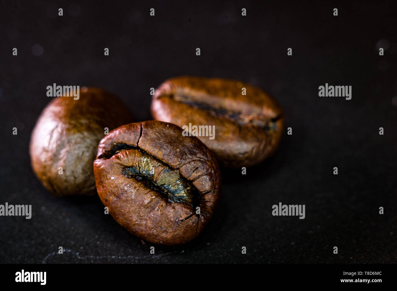 Brown roasted coffee beans on black background, close-up, macro Stock ...
