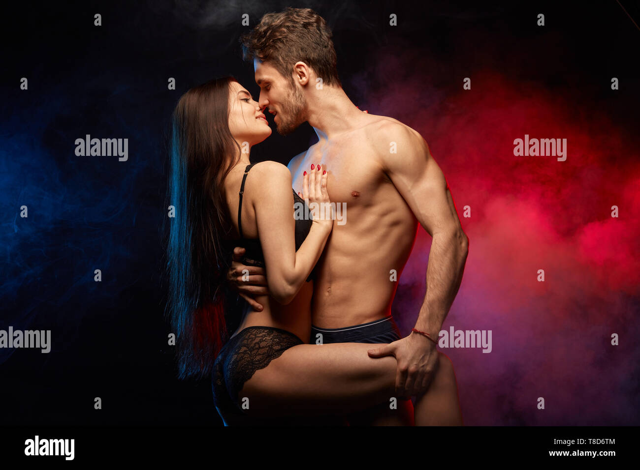 couple having sex in bed woman wearing black bra Stock Photo - Alamy