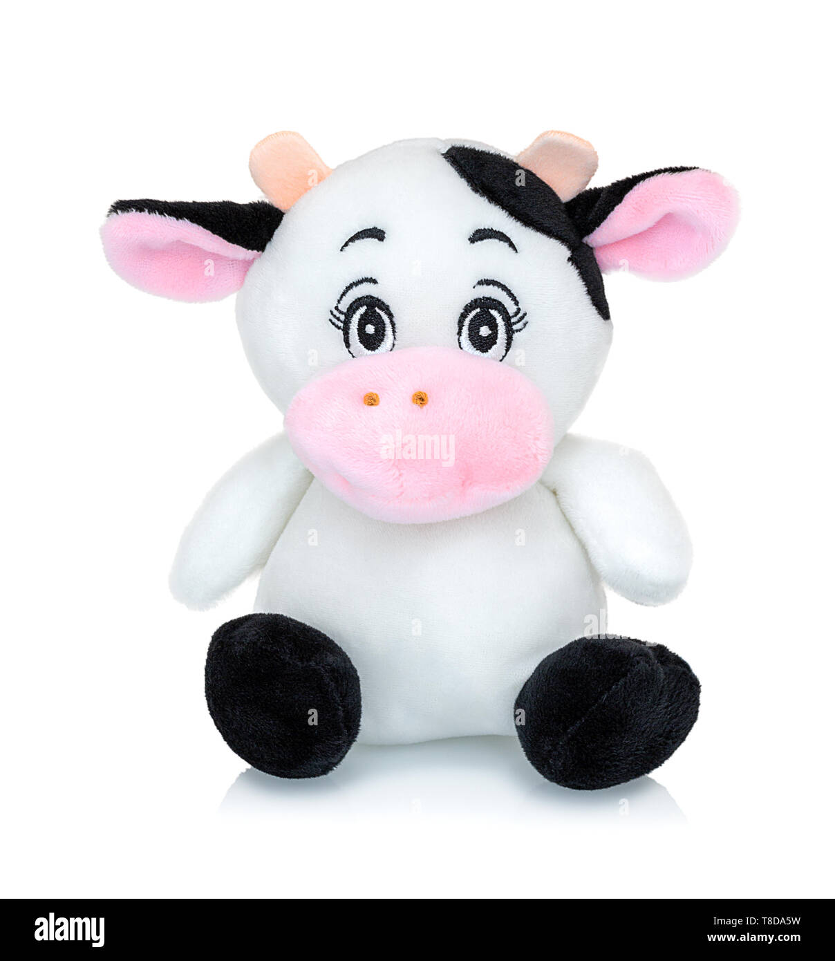 Cow plushie doll isolated on white background with shadow reflection