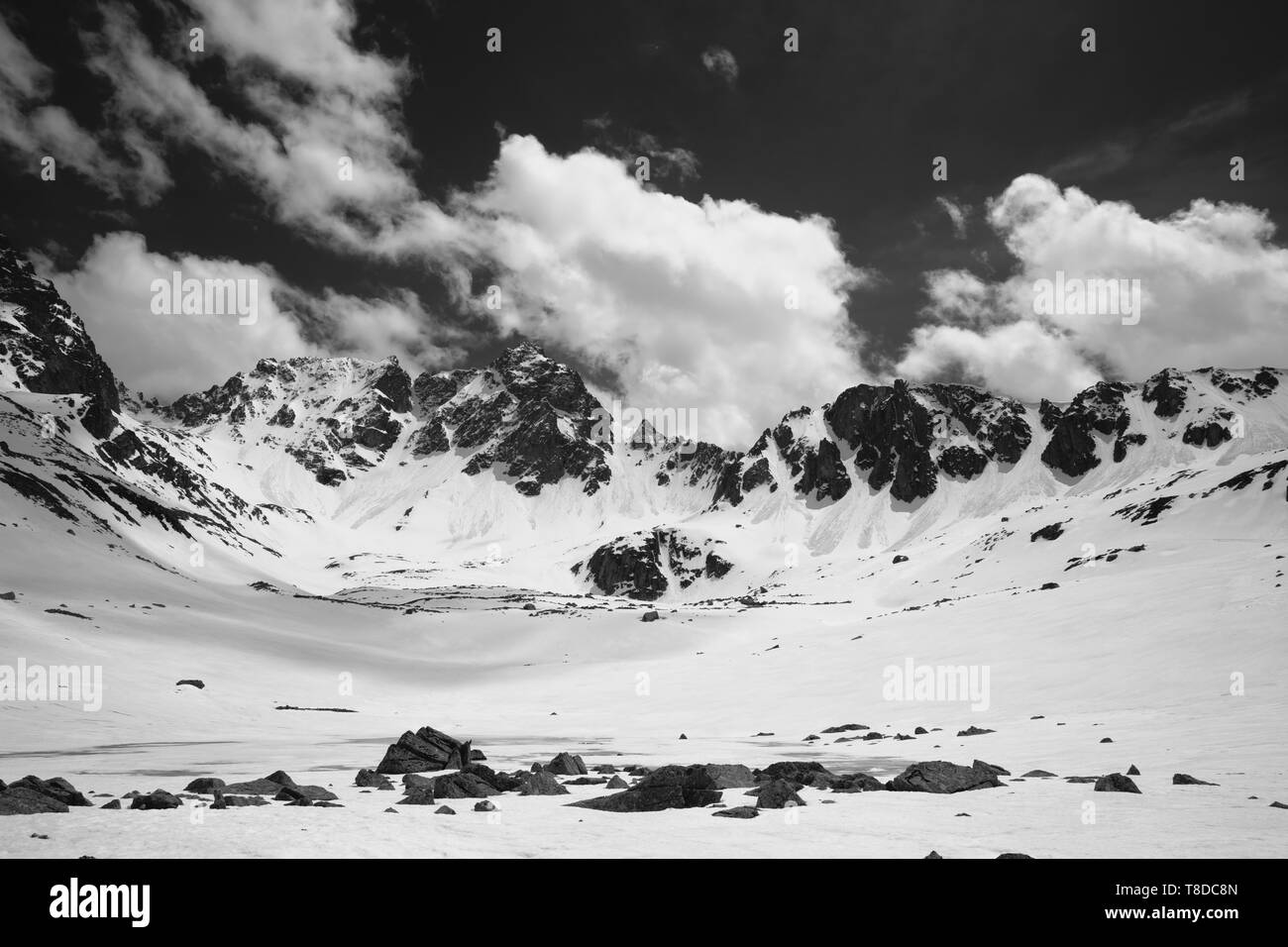 Plateau in high snowy mountains with frozen lake covered snow and cloudy sky at sunny spring day. Turkey, Kachkar Mountains, highest part of Pontic Mo Stock Photo