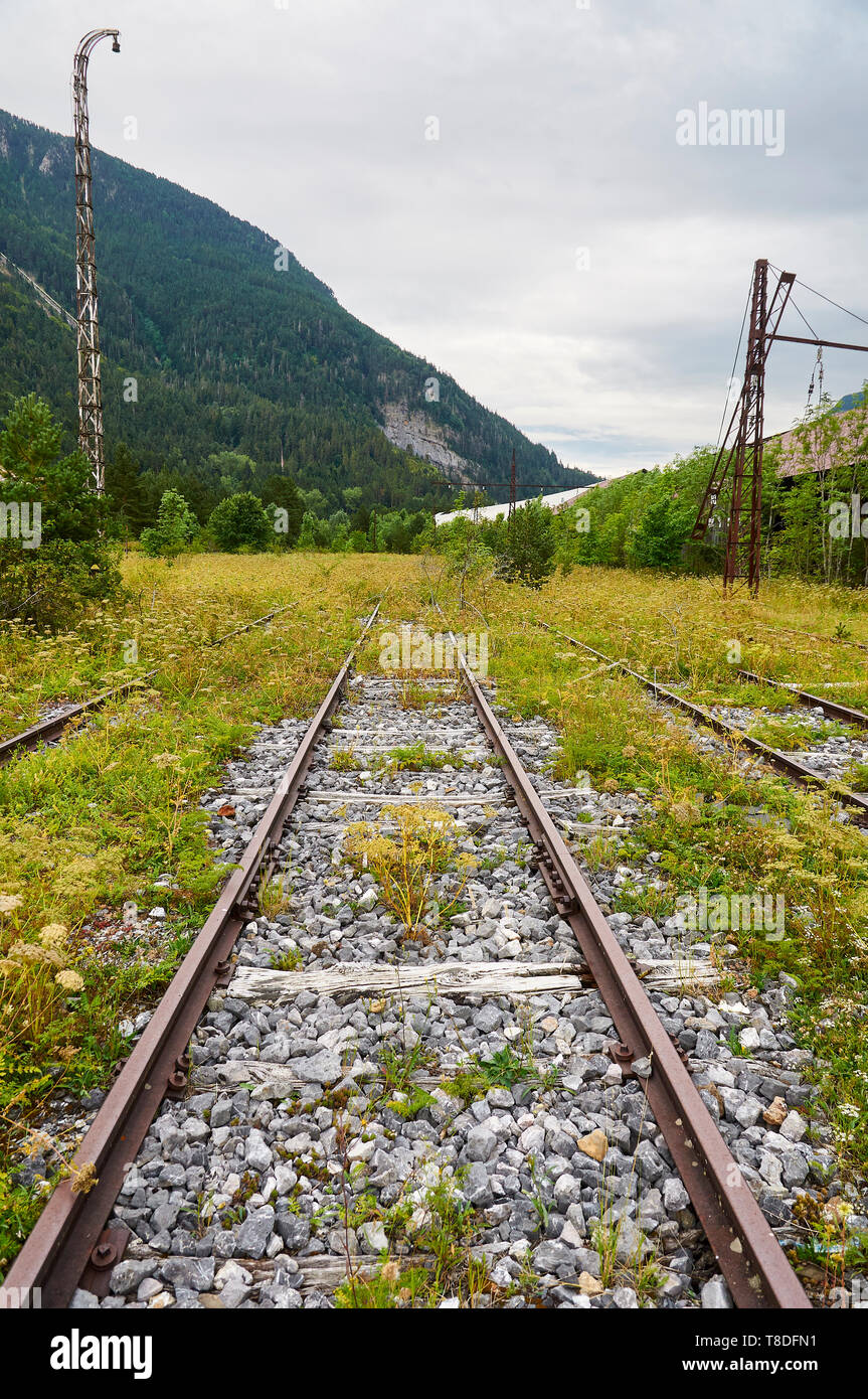 Railroad tracks pointed to the infinite at the abandoned Canfranc International railway station (Canfranc, Pyrenees, Huesca, Aragon, Spain) Stock Photo