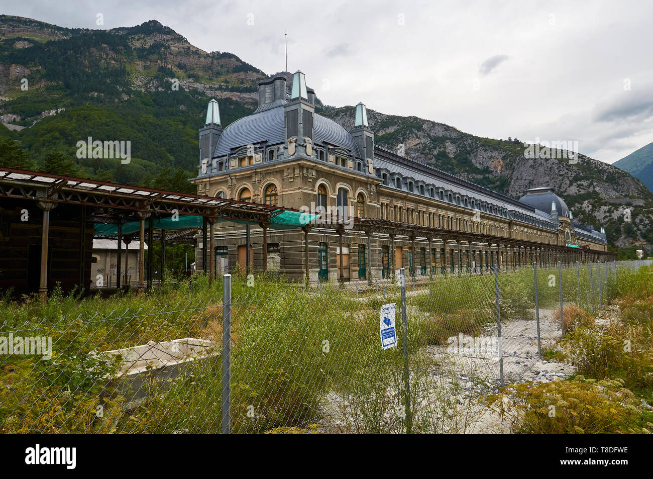 Back side of the abandoned Canfranc International railway station with Borreguil de la Cuca peak in the background (Pyrenees, Huesca, Aragon, Spain) Stock Photo