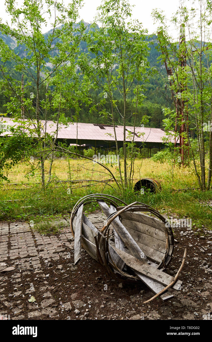 Crushed antique wood barrel at the abandoned Canfranc International railway station (Canfranc, Pyrenees, Jacetania, Huesca, Aragon, Spain) Stock Photo