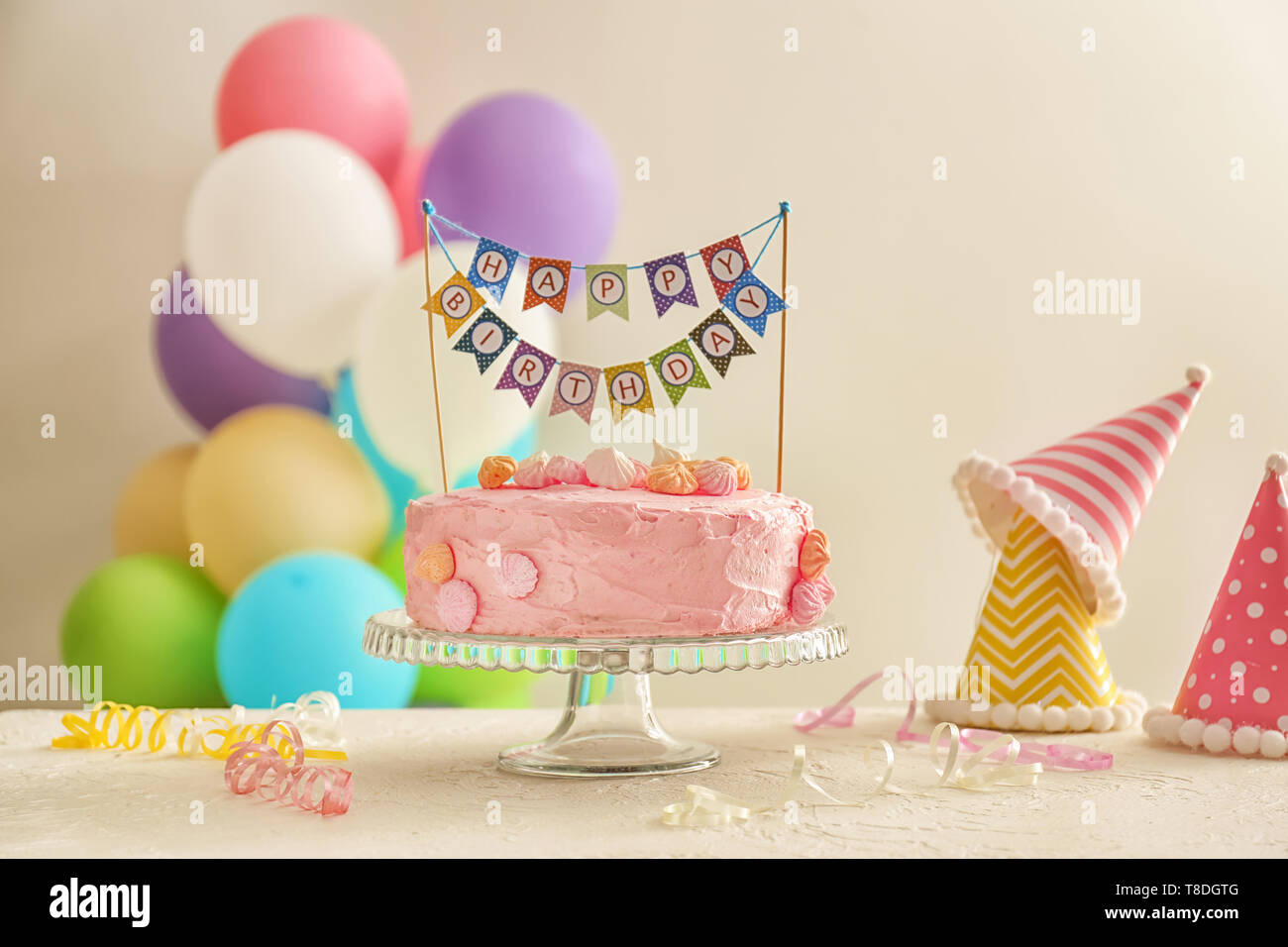 Stand with beautiful tasty birthday cake on table Stock Photo - Alamy