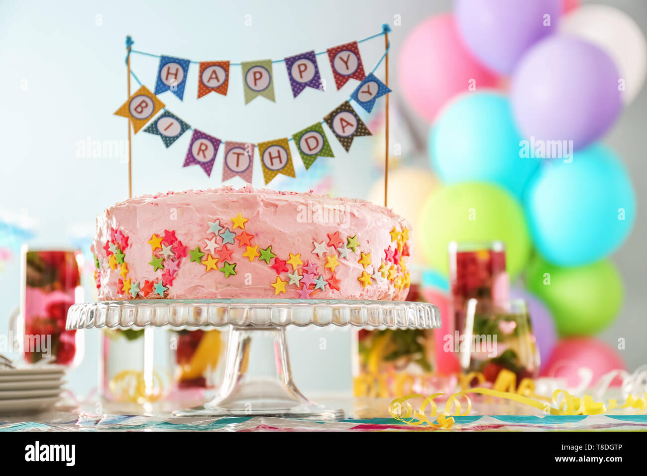 Stand with beautiful tasty birthday cake on table Stock Photo - Alamy