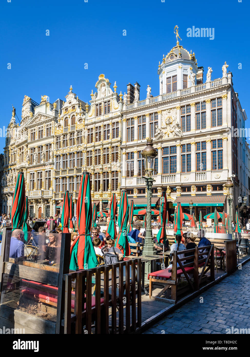 The Grand Place in Brussels, Belgium, is lined by opulent guild houses, with richly decorated facades, and by terraces of cafes and restaurants. Stock Photo