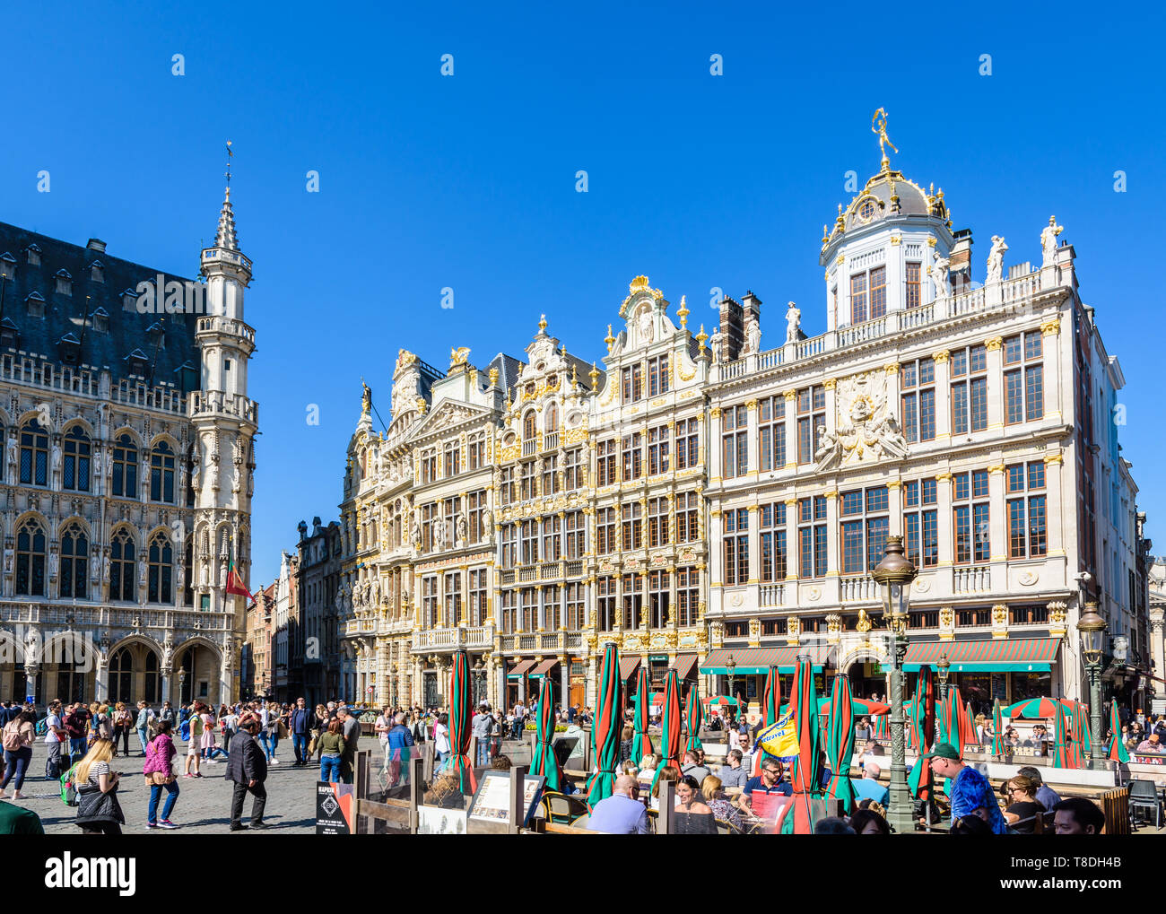 The Grand Place in Brussels, Belgium, is lined by opulent guild houses, with richly decorated facades, and by terraces of cafes and restaurants. Stock Photo